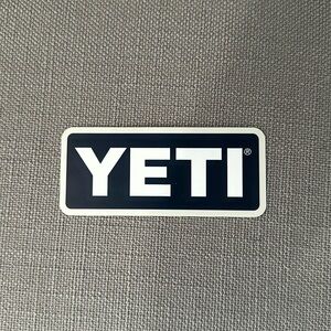Yeti sticker. Gray trim with dark blue background and white writing. Soft edges
